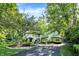Picturesque home exterior with manicured lawn, mature trees, and paved driveway at 4530 Chase Oak Ct, Zionsville, IN 46077