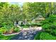 Charming stone and stucco home with lush landscaping and a paved driveway at 4530 Chase Oak Ct, Zionsville, IN 46077
