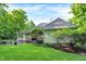 Beautiful home exterior with a covered patio and lush green lawn at 4530 Chase Oak Ct, Zionsville, IN 46077