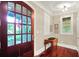 Inviting foyer featuring a wood front door with glass, hardwood floors, and natural light at 4530 Chase Oak Ct, Zionsville, IN 46077