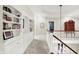 Upstairs hallway features built in bookshelves and detailed trim work at 4530 Chase Oak Ct, Zionsville, IN 46077