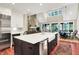 Large kitchen with island seating, stainless appliances, and open concept to living area at 4530 Chase Oak Ct, Zionsville, IN 46077