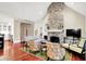 Inviting living room with stone fireplace, comfortable seating, and hardwood floors at 4530 Chase Oak Ct, Zionsville, IN 46077