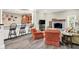 Open living area with a stone fireplace, bar seating, and a glimpse of the kitchen at 4530 Chase Oak Ct, Zionsville, IN 46077