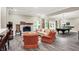 Inviting living room with a stone fireplace, plush seating, and a billiards table at 4530 Chase Oak Ct, Zionsville, IN 46077