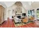Sunlit living room with stone fireplace, comfortable seating, and access to backyard at 4530 Chase Oak Ct, Zionsville, IN 46077