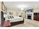 Serene primary bedroom featuring a fireplace and neutral decor with soft lighting at 4530 Chase Oak Ct, Zionsville, IN 46077