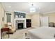 Inviting primary bedroom showcasing a fireplace, neutral tones, and large windows at 4530 Chase Oak Ct, Zionsville, IN 46077