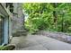 A stone patio overlooks the backyard and is bordered by a stone retaining wall at 4530 Chase Oak Ct, Zionsville, IN 46077