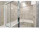 Modern glass-enclosed shower with a bench seat and multiple shower heads for a spa-like experience at 4530 Chase Oak Ct, Zionsville, IN 46077