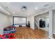 Finished basement featuring a projector screen, laundry area, and hardwood floors at 4840 E 77Th St, Indianapolis, IN 46250