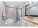 Well-lit bathroom with neutral colors, shower and tub, and a large mirror at 4840 E 77Th St, Indianapolis, IN 46250