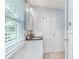 Well-lit bathroom with a white sink vanity and a window with wood blinds at 4840 E 77Th St, Indianapolis, IN 46250