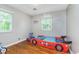 Fun bedroom design with a race car bed and wood flooring at 4840 E 77Th St, Indianapolis, IN 46250