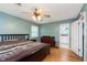 Bright bedroom with hardwood floors, ceiling fan and ensuite bathroom access at 4840 E 77Th St, Indianapolis, IN 46250