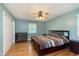 Comfortable bedroom featuring a dark wood bed frame, ceiling fan, and windows at 4840 E 77Th St, Indianapolis, IN 46250