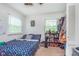 Comfortable bedroom with two windows, a floral patterned bedspread, and a shoe rack at 4840 E 77Th St, Indianapolis, IN 46250