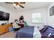 Relaxing bedroom featuring a blue and purple bedspread, a window, and a wood dresser at 4840 E 77Th St, Indianapolis, IN 46250