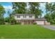 Charming two-story home with a well-manicured lawn and beautiful landscaping at 4840 E 77Th St, Indianapolis, IN 46250
