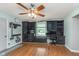 Bright home office featuring custom black built-ins, hardwood floors, and a stylish ceiling fan at 4840 E 77Th St, Indianapolis, IN 46250