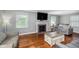 Cozy living room with hardwood floors, a fireplace, and comfortable seating at 4840 E 77Th St, Indianapolis, IN 46250