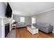 Spacious living room featuring a fireplace, hardwood floors, and comfortable sofas at 4840 E 77Th St, Indianapolis, IN 46250
