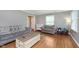 Cozy living room with hardwood floors, gray walls, and comfortable gray sofa and chair at 4840 E 77Th St, Indianapolis, IN 46250