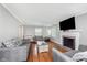 Bright living room featuring hardwood floors, neutral walls, and a cozy fireplace at 4840 E 77Th St, Indianapolis, IN 46250