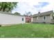 The property features a grassy backyard with a detached garage and a view of neighboring houses at 4922 Brookville Rd, Indianapolis, IN 46201