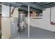Unfinished basement featuring painted walls and floor, mechanical equipment, and exposed ceiling at 4922 Brookville Rd, Indianapolis, IN 46201
