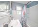 This bathroom features a white vanity, blue walls, and a shower and tub at 4922 Brookville Rd, Indianapolis, IN 46201