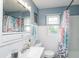 Bathroom with a white vanity, blue walls, and shower/tub combo at 4922 Brookville Rd, Indianapolis, IN 46201