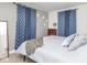 This bedroom features blue curtains, a white bed, and a gray accent wall at 4922 Brookville Rd, Indianapolis, IN 46201