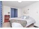 This bedroom features a bookshelf, bed, and blue patterned curtains at 4922 Brookville Rd, Indianapolis, IN 46201