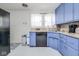 Functional kitchen with blue cabinets, updated appliances, and ample counter space at 4922 Brookville Rd, Indianapolis, IN 46201