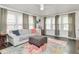 Cozy living room with large windows, comfortable seating, and neutral color palette at 4922 Brookville Rd, Indianapolis, IN 46201