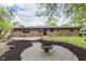 Backyard featuring a fire pit, patio, and brick exterior at 5982 Melbourne Rd, Indianapolis, IN 46228