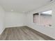 Bedroom featuring wood floors, fresh paint, and a large window at 5982 Melbourne Rd, Indianapolis, IN 46228