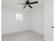 Carpeted bedroom featuring a ceiling fan and natural light from a window at 5982 Melbourne Rd, Indianapolis, IN 46228