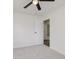 Carpeted bedroom features a ceiling fan and an open door to another room at 5982 Melbourne Rd, Indianapolis, IN 46228