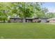 Brick home with an attached garage and a green front lawn shaded by mature trees at 5982 Melbourne Rd, Indianapolis, IN 46228