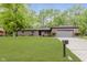 Brick home with a well-manicured lawn, mature trees, and an attached two-car garage at 5982 Melbourne Rd, Indianapolis, IN 46228