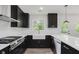 Modern kitchen features stainless steel appliances, white countertop, and white subway tile backsplash at 5982 Melbourne Rd, Indianapolis, IN 46228