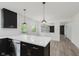 Modern kitchen with black cabinets, white countertops, stainless steel appliances and backyard views at 5982 Melbourne Rd, Indianapolis, IN 46228
