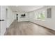 Bright and open living room with large windows and an open view into the kitchen at 5982 Melbourne Rd, Indianapolis, IN 46228