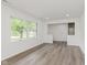 Living room featuring wood floors, fresh paint, a large window, and an open concept at 5982 Melbourne Rd, Indianapolis, IN 46228