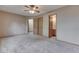 Cozy bedroom with plush carpet, a ceiling fan, and ensuite access at 6010 Rocky River Dr, Indianapolis, IN 46221