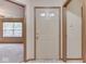The front door opens to neutral-colored walls, trim, and carpeted floors, adjacent to a large living area at 6010 Rocky River Dr, Indianapolis, IN 46221