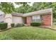 A well-maintained single-story home with a mix of red brick and cream-colored siding, plus manicured bushes at 6010 Rocky River Dr, Indianapolis, IN 46221