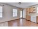 The kitchen is adjacent to the dining area, with wood floors, simple cabinets, and a door to the exterior at 6010 Rocky River Dr, Indianapolis, IN 46221
